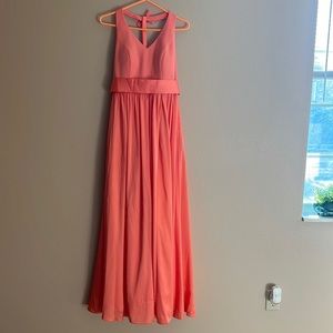 Peach colored long dress with bow accents
